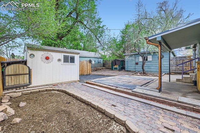 319 S Institute St, Colorado Springs, CO 80903 - wooden terrace with an outdoor structure, a patio, and a fenced backyard