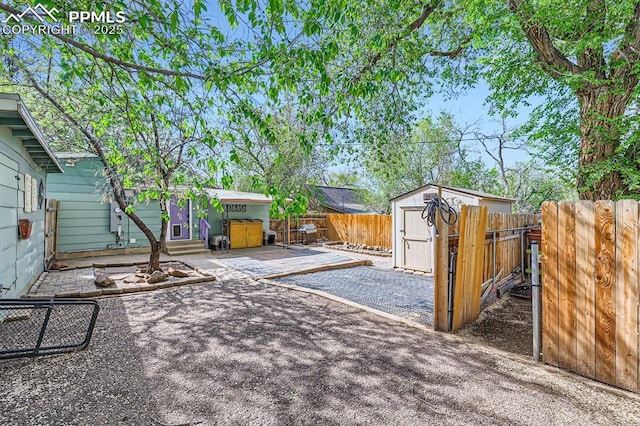 319 S Institute St, Colorado Springs, CO 80903 - fenced backyard with a patio, a shed, and an outdoor structure