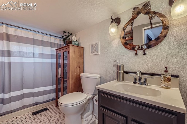 319 S Institute St, Colorado Springs, CO 80903 - full bath with a textured wall, toilet, vanity, tile patterned floors, and curtained shower