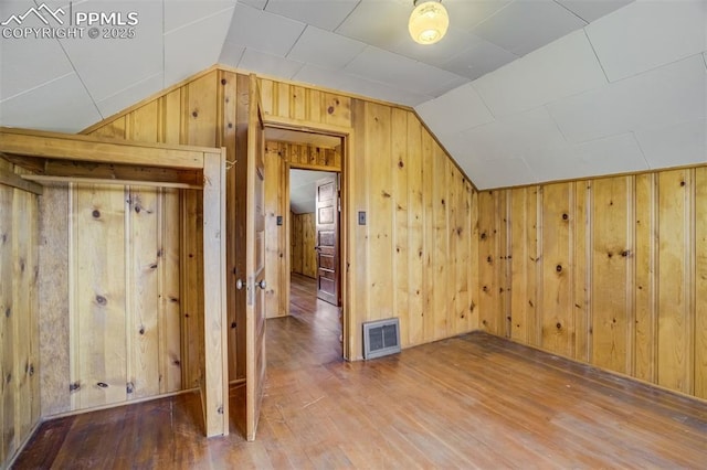 1475 S Peyton Hwy, Calhan, CO 80808 - bonus room with vaulted ceiling, wooden walls, and wood finished floors