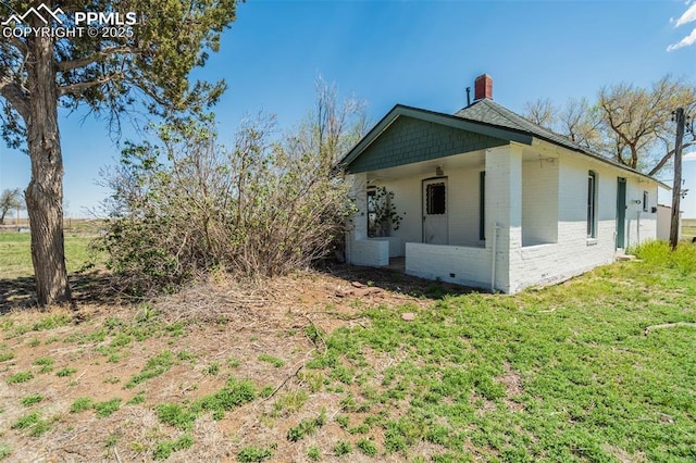 1475 S Peyton Hwy, Calhan, CO 80808 - view of property exterior with brick siding and a chimney