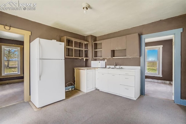 1475 S Peyton Hwy, Calhan, CO 80808 - kitchen with white appliances, light carpet, and healthy amount of natural light