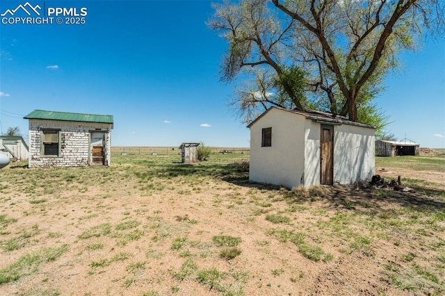 1475 S Peyton Hwy, Calhan, CO 80808 - view of yard featuring a storage unit and an outbuilding