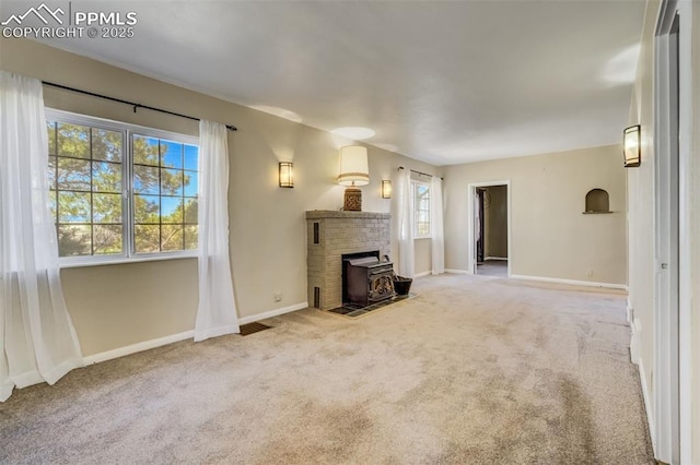 1475 S Peyton Hwy, Calhan, CO 80808 - unfurnished living room with carpet, a wood stove, and baseboards
