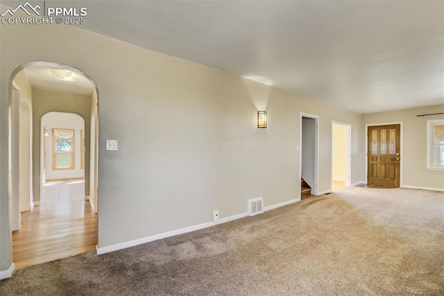 1475 S Peyton Hwy, Calhan, CO 80808 - carpeted spare room featuring arched walkways, baseboards, and stairway