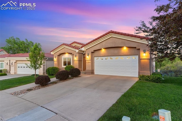 2744 La Strada Grande Hts, Colorado Springs, CO 80906 - ranch-style house featuring concrete driveway, stucco siding, a tile roof, and an attached garage