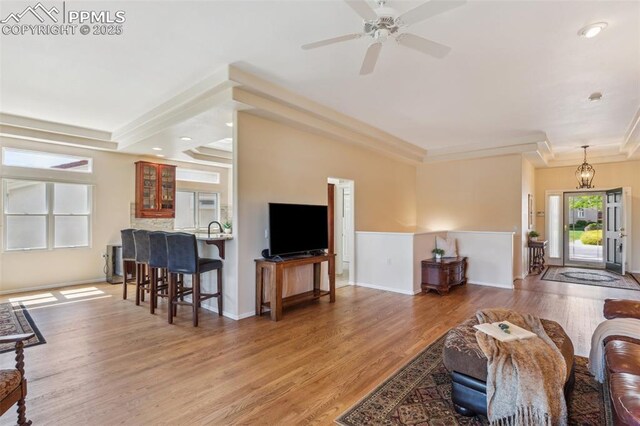2744 La Strada Grande Hts, Colorado Springs, CO 80906 - living area with light wood-style flooring, a ceiling fan, baseboards, recessed lighting, and crown molding