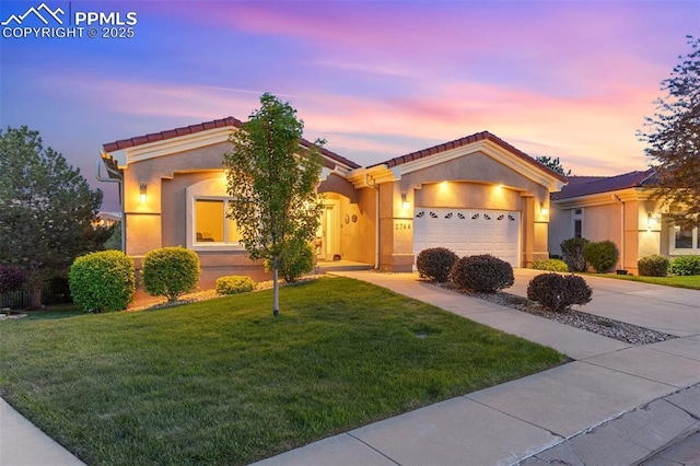 2744 La Strada Grande Hts, Colorado Springs, CO 80906 - ranch-style house featuring an attached garage, a front lawn, concrete driveway, stucco siding, and a tiled roof