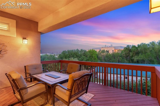 2744 La Strada Grande Hts, Colorado Springs, CO 80906 - deck at dusk featuring outdoor dining area