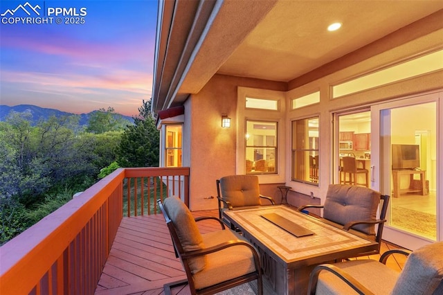2744 La Strada Grande Hts, Colorado Springs, CO 80906 - deck at dusk featuring a mountain view
