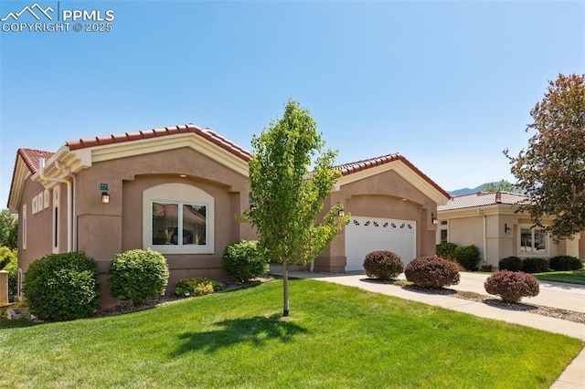 2744 La Strada Grande Hts, Colorado Springs, CO 80906 - mediterranean / spanish home with an attached garage, a front yard, driveway, and stucco siding