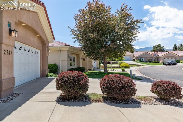 2744 La Strada Grande Hts, Colorado Springs, CO 80906 - view of yard featuring a garage, concrete driveway, and a residential view