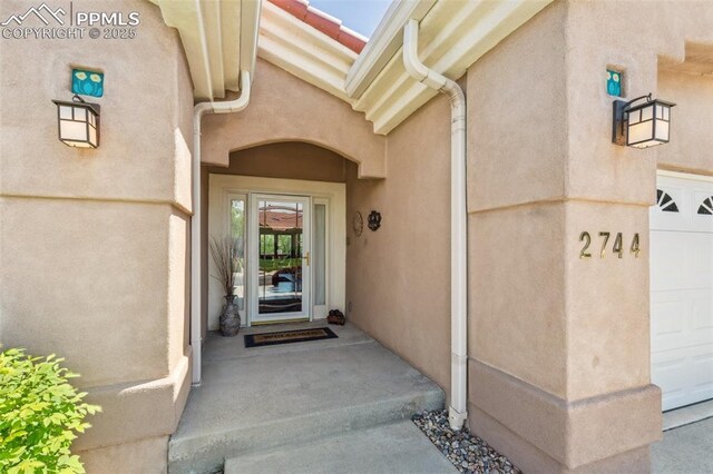2744 La Strada Grande Hts, Colorado Springs, CO 80906 - doorway to property with stucco siding