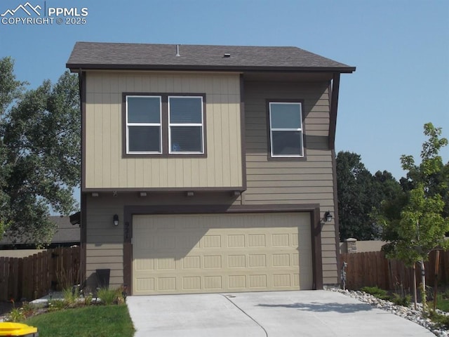 921 Grissom Dr, Colorado Springs, CO 80915 - view of front of house featuring a garage, fence, concrete driveway, and roof with shingles