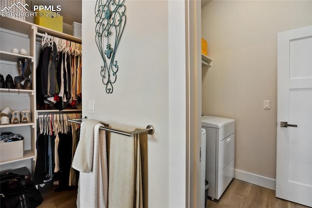 washroom with wood finished floors and baseboards
