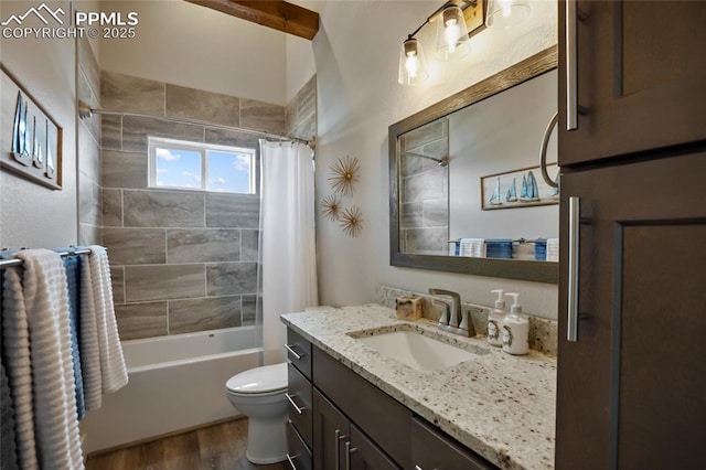 bathroom with wood finished floors, toilet, vanity, and shower / bath combo
