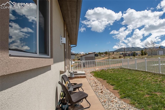 view of yard with a mountain view, a patio, and an outbuilding