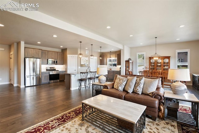 living area featuring dark wood-type flooring, recessed lighting, and baseboards
