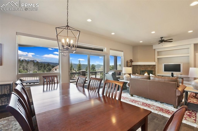 dining room featuring a chandelier, recessed lighting, ceiling fan, wood finished floors, and built in shelves