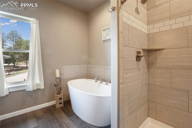full bath with tiled shower, wood finished floors, and a freestanding bath