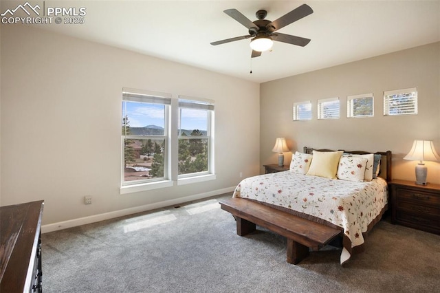 bedroom featuring multiple windows, baseboards, carpet, and ceiling fan