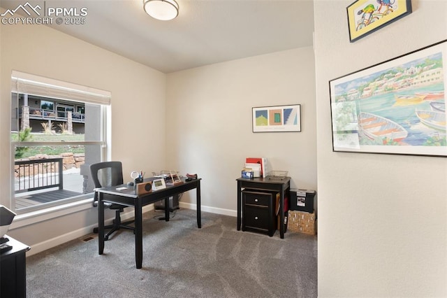 carpeted office featuring baseboards
