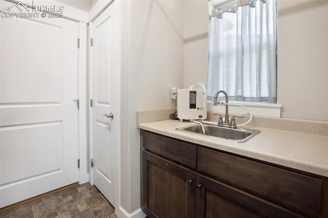 bathroom with vanity and stone finish floors