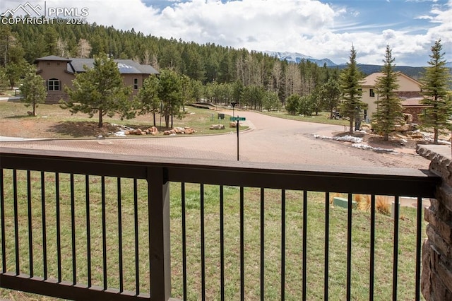 balcony with a wooded view and a mountain view