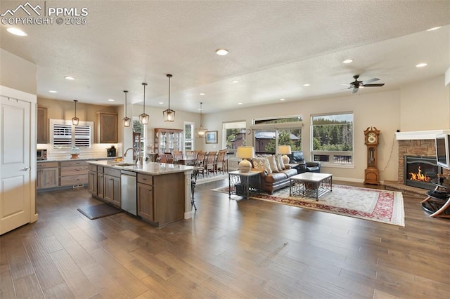 kitchen featuring open floor plan, dishwasher, ceiling fan, dark wood finished floors, and recessed lighting