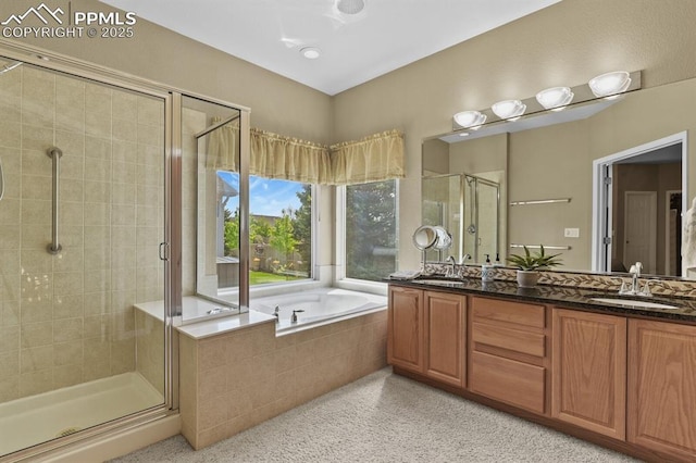 bathroom with a stall shower, a bath, double vanity, and speckled floor