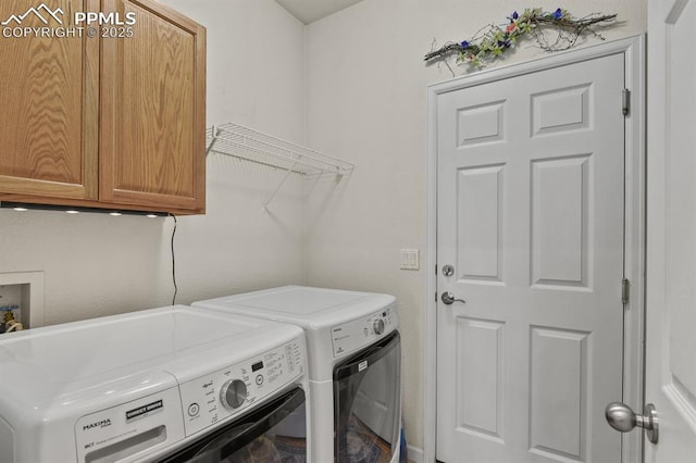 laundry room featuring independent washer and dryer and cabinet space
