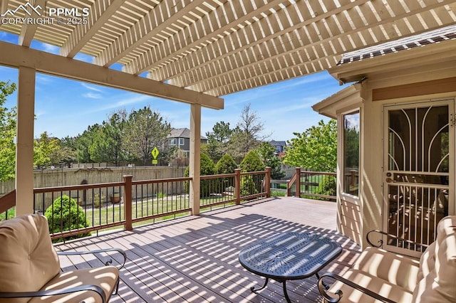 deck featuring fence and a pergola