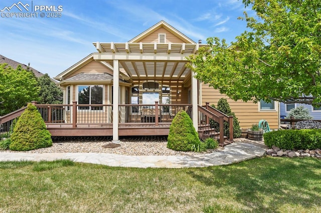 back of property with a lawn and a wooden deck