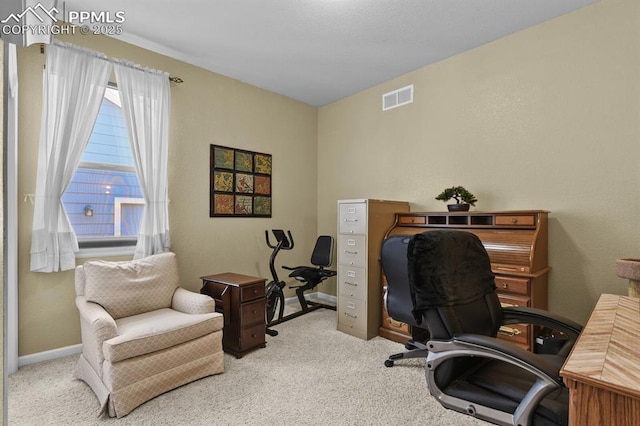 carpeted home office featuring baseboards