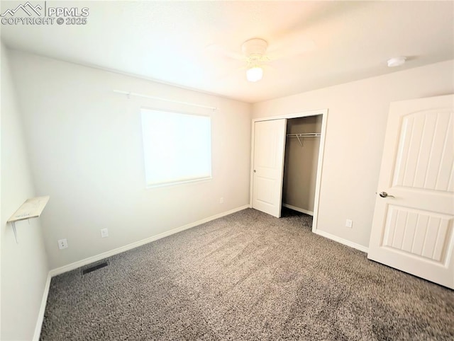 unfurnished bedroom with carpet, baseboards, and a closet