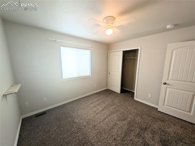 unfurnished bedroom with carpet floors, baseboards, a closet, and a ceiling fan