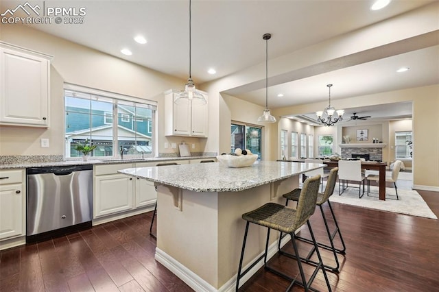 8451 Meadow Wing Cir, Colorado Springs, CO 80927 - kitchen with dishwasher, healthy amount of natural light, white cabinetry, open floor plan, and recessed lighting