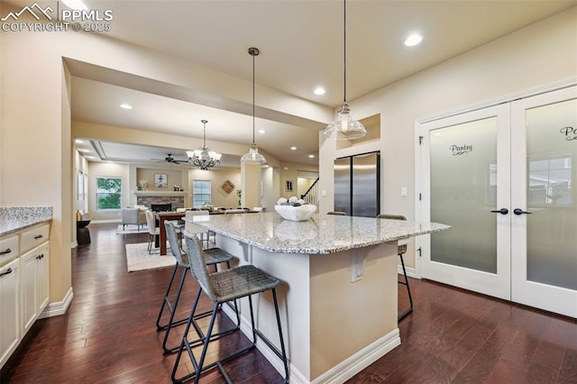 8451 Meadow Wing Cir, Colorado Springs, CO 80927 - kitchen with freestanding refrigerator, french doors, dark wood-style floors, and recessed lighting