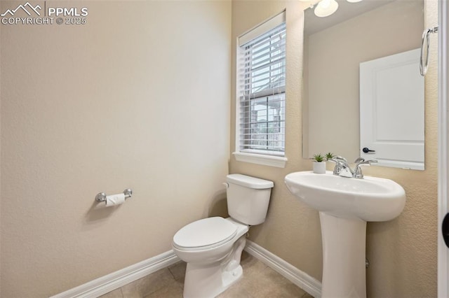 8451 Meadow Wing Cir, Colorado Springs, CO 80927 - bathroom with toilet, tile patterned floors, baseboards, and a sink