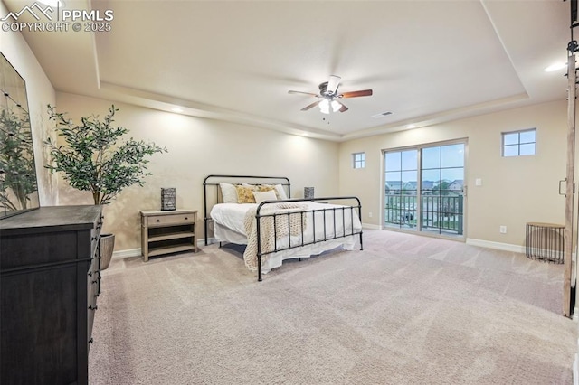8451 Meadow Wing Cir, Colorado Springs, CO 80927 - bedroom featuring light colored carpet, a tray ceiling, access to exterior, and recessed lighting