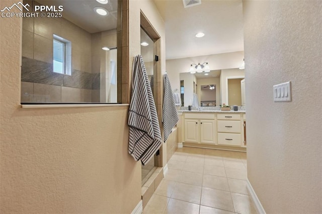 8451 Meadow Wing Cir, Colorado Springs, CO 80927 - bathroom with a textured wall, vanity, a walk in shower, tile patterned floors, and baseboards