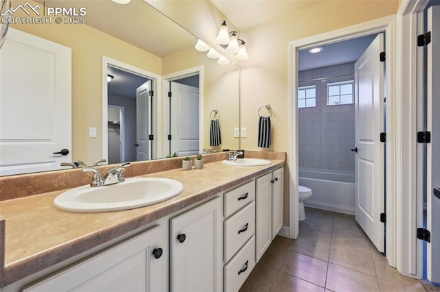 8451 Meadow Wing Cir, Colorado Springs, CO 80927 - full bathroom with double vanity, toilet, tile patterned floors, and shower / bathtub combination