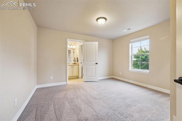 8451 Meadow Wing Cir, Colorado Springs, CO 80927 - unfurnished bedroom featuring carpet floors, baseboards, and ensuite bath