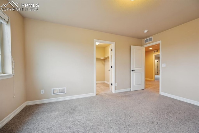 8451 Meadow Wing Cir, Colorado Springs, CO 80927 - unfurnished bedroom with carpet, a spacious closet, and baseboards