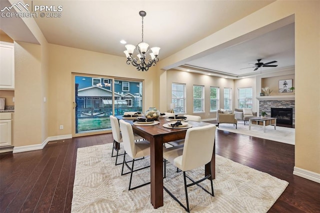 8451 Meadow Wing Cir, Colorado Springs, CO 80927 - dining room featuring a fireplace, wood-type flooring, baseboards, and a chandelier