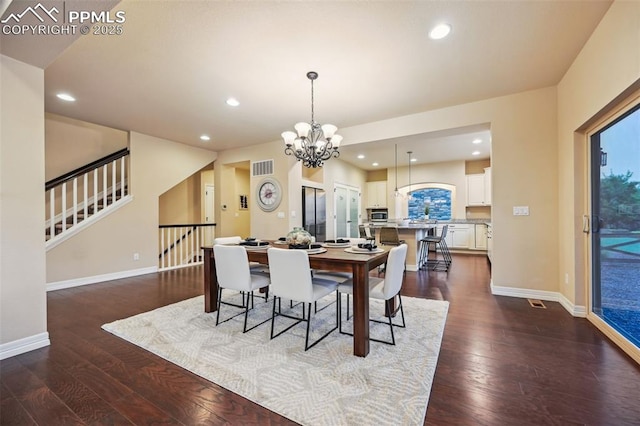 8451 Meadow Wing Cir, Colorado Springs, CO 80927 - dining area with recessed lighting, dark wood finished floors, a chandelier, baseboards, and stairway