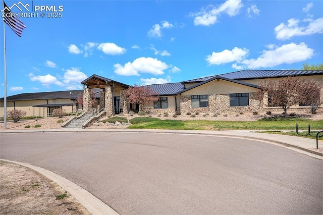 12543 Pine Valley Cir, Peyton, CO 80831 - view of front of property with stone siding, a standing seam roof, and a metal roof