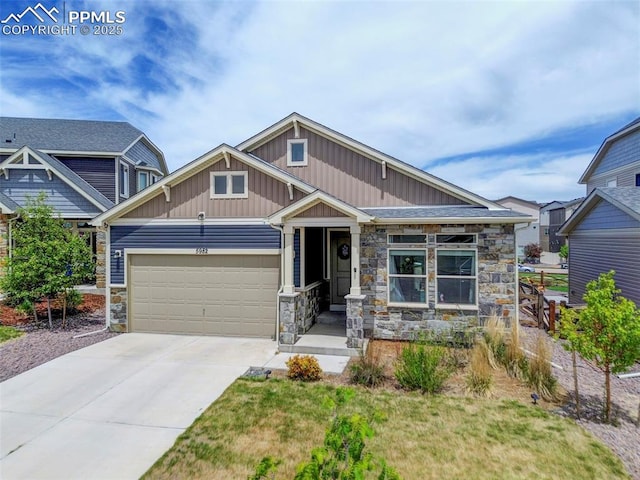 craftsman house with stone siding, a garage, board and batten siding, and concrete driveway