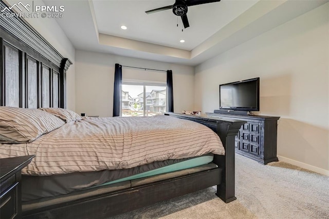 bedroom with light carpet, baseboards, recessed lighting, a ceiling fan, and a raised ceiling