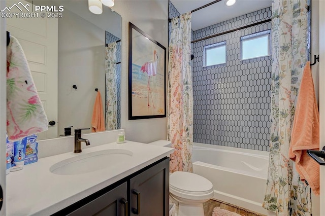 bathroom with toilet, shower / bath combo, and vanity